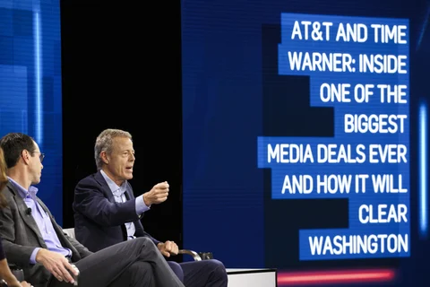 Randall Stephenson, chairman and chief executive officer of AT&T., left, listens while Jeffrey “Bewkes, chairman and chief executive officer of Time Warner, speaks during at a conference in California, U.S. (Photographer: Patrick T. Fallon/Bloomberg)