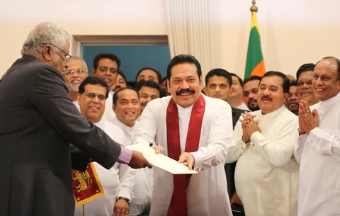 Sri Lanka’s prime minister Mahinda Rajapaksa, hands over inaugural documents to an official during his duties assuming ceremony in Colombo, Sri Lanka, on Oct. 29, 2018. (Photograph: AP/PTI)
