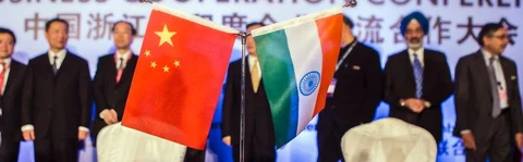 The national flags of China, left, and India sit on a desk during a conference in New Delhi, India. (Photographer: Prashanth Vishwanathan/Bloomberg)