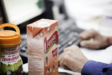 A container of chyawanprash and a carton of apple juice sit on a counter at a Patanjali Ayurved Ltd. store in New Delhi. (Photographer: Udit Kulshrestha/Bloomberg)