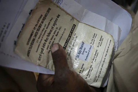 A patient holds his medical records as he waits at the Acharya Tulsi Regional Cancer Treatment & Research Institute in Bikaner, Rajasthan. (Photographer: Prashanth Vishwanathan/Bloomberg)
