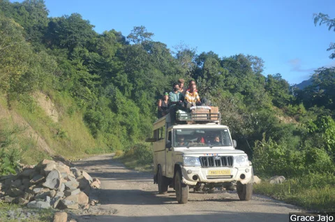 No state transport plies toward Leisang village, and villagers use private trucks or other overloaded shared vehicles.