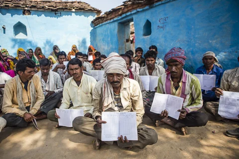 Villagers hold up their job cards with no entries for MGNREGA in Tikamgarh, Madhya Pradesh. (Photographer: Prashanth Vishwanathan/Bloomberg)