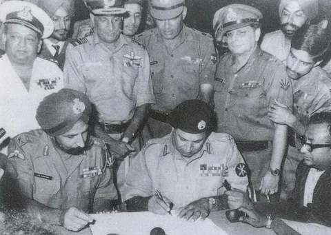 Pakistan’s Lt. Gen. AAK Niazi signing the Instrument of Surrender, while India’s Lt. Gen. JS Aurora looks on, in Dhaka, on Dec. 16, 1971. (Photograph: Indian Navy)
