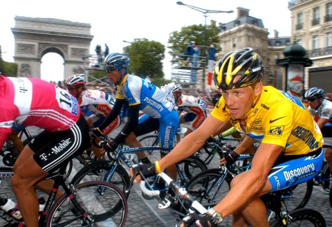 Lance Armstrong rides in front of the Arc de Triomphe on the Champs-Elysees while winning the Tour de France in Paris in 2005. (Photographer: Alastair Miller/Bloomberg News). 