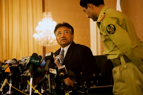 Then President of Pakistan General Pervez Musharraf speaks to an aide before the start of a news conference in Islamabad, Pakistan. (Photographer: Adam Ferguson/Bloomberg News)
