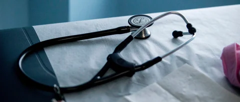 A stethoscope sits on an examination table in an exam room at a health center. (Photographer: Andrew Harrer/Bloomberg)