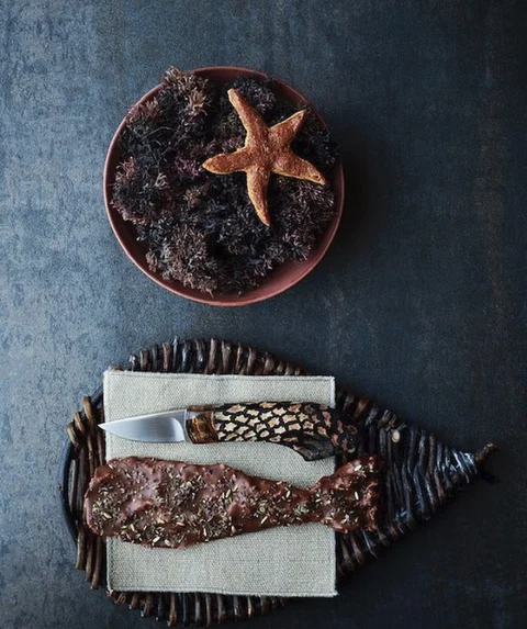 A starfish made out of gooey fudge flavored with saffron and cardamom. Below is cod skin cooked until crisp and then dipped in dark chocolate with sweet spices on top. (Image courtesy: <a href="https://www.instagram.com/reneredzepinoma/">reneredzepinoma</a>)