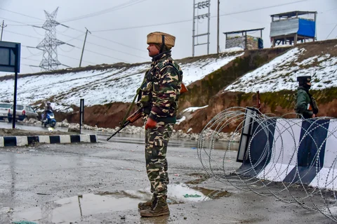 An army soldier stands guard near the site of the suicide bomb attack at Lathepora Awantipora in Pulwama district of Jammu & Kashmir, on Feb. 14, 2019. (Photographer: S Irfan/PTI)