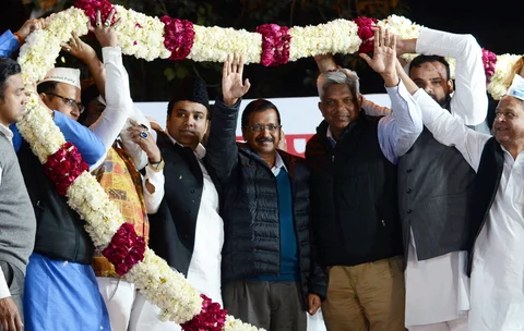 Arvind Kejriwal waves as AAP leaders garland him during a public meeting in New Delhi, on Feb. 20, 2019. (Photograph: PTI)