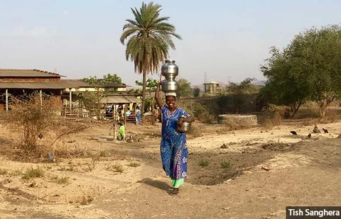 A woman in Velgaon village, Palghar tehsil, Thane district, leaves home to collect water from the nearest well. Without piped water supply, many women spend multiple hours a day collecting and ferrying water to their homes in this village, just 95 km from Mumbai, India’s thriving financial hub.