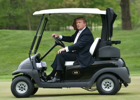 Donald Trump drives a golf cart in Potomac Falls, Virginia. (Photographer: Mannie Garcia/Bloomberg News)