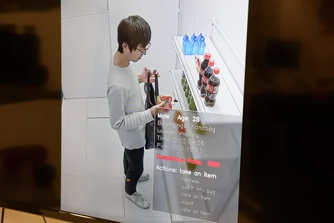 A screen shows a Vaak employee handling a product in a mock store (Photographer: Akio Kon/Bloomberg) 