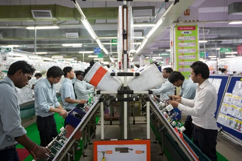 Workers assemble wire harnesses at the Motherson Sumi Systems plant in Faridabad, India. (Photographer: Brent Lewin/Bloomberg)
