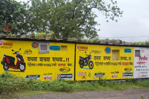 An advertisement for motorcycles is displayed on the side of a house in the village of Ghansoli, Maharashtra, India (Photographer: Karen Dias/Bloomberg) 