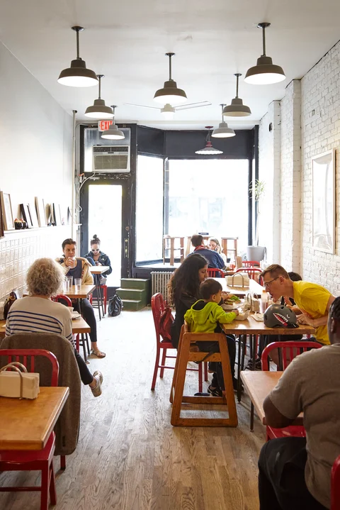 A multitude of offbeat sandwiches, chosen from the colorful menu board (left), has won Court Street Grocers a mini-empire across Manhattan and Brooklyn from its original Carroll Gardens location. 