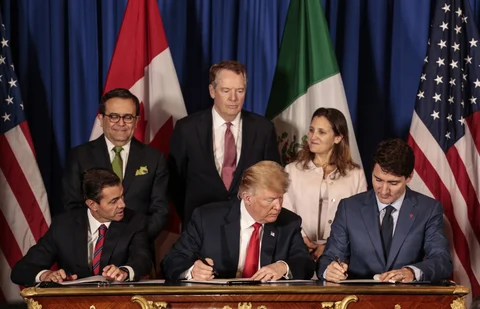 Enrique Pena Nieto, then Mexico’s president, U.S. president Donald Trump, and Justin Trudeau, Canada’s prime minister, sign the United States-Mexico-Canada Agreement, in Buenos Aires, on Nov. 30, 2018. (Photographer: Sarah Pabst/Bloomberg)