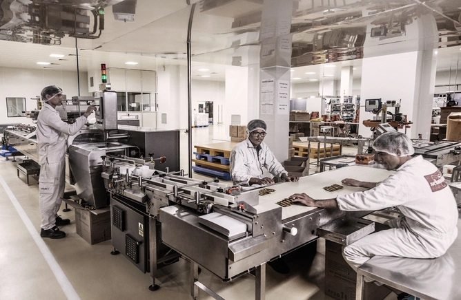 Top and above: Chocolate bars being produced a ta Rajhans(Desai-Jain)Group plant in Surat . Photograph by Narendra Bisht