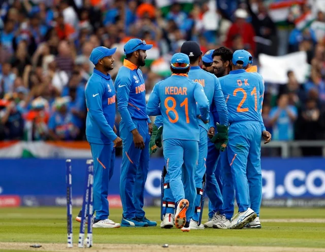 Indian squad celebrates the dismissal of Henry Nicholls during the Semi Final match against New Zealand at Old Trafford in Manchester on Tuesday.