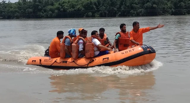 NDRF personnel during the rescue operation of residents from the flood-affected area of Morigaon