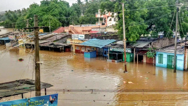 A view of Malaprabha river water flooding the Munavalli village after heavy rain, in Belgavi, Karnataka, Wednesday, Aug 7, 2019.