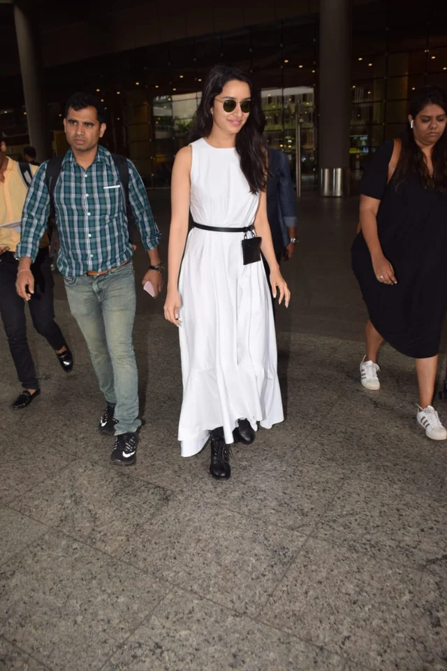 Shraddha Kapoor on the other hand was snapped on her way back from chennai. The actress is busy promoting her tri lingual film, Saaho with Prabhas. She was seen wearing a full length white dress with a black booth and a basic belt across her waist.