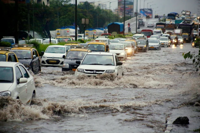 Vehicles move on flooded Western Express highway after heavy rainfall near Bandra