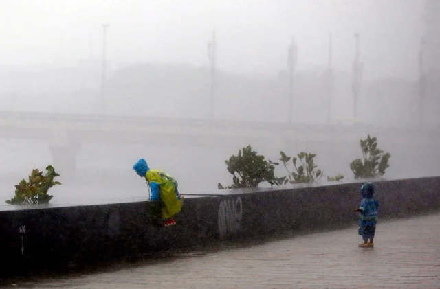 Kids enjoying during heavy rains at Worli Sea Face in Mumbai