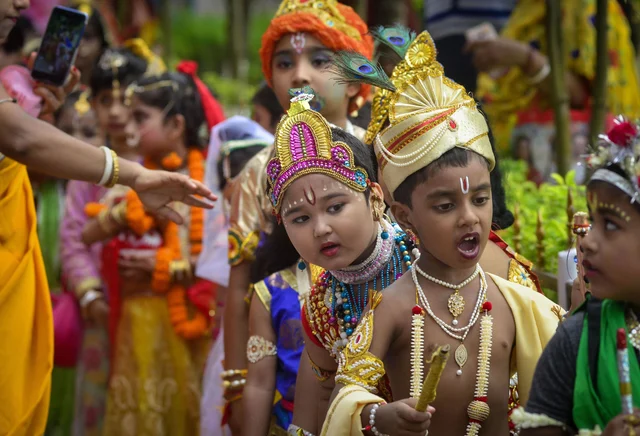 Students dressed up as Lord Krishna take part in 'Janmashtami' festival celebrations at a school, in Agartala