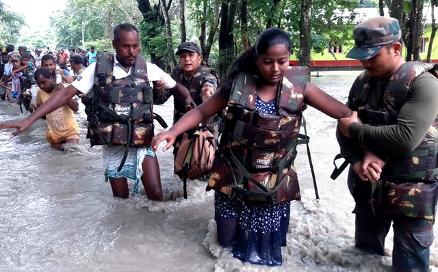 Indian army personnel rescue residents from the flood-affected Village Dhamdhama in Nalbari, Assam on Wednesday