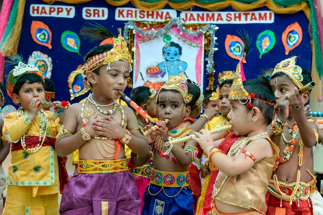 Children dressed as Hindu God Lord Krishna play flutes as they take part in celebrations on the occasion of Janamashtami, the birthday of Lord Krishna, in Hyderabad