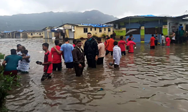 Police rescue people who are stuck in flooded water due to heavy rain in Thane, Maharashtra