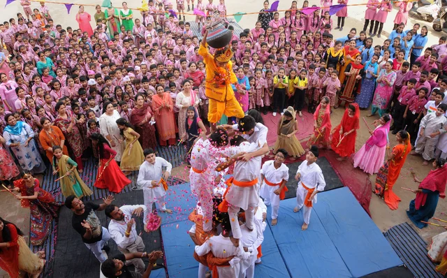 Students form a human pyramid as they try to break 'dahi-handi' on the occasion of Janmashtami festival at a school, in Amritsar