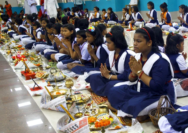 School students offer prayer during the mass worship on the occasion of 'Ganesh Chaturthi' festival in Bhubaneswar