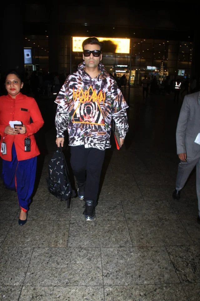Karan Johar maintaining his uptown funk was seen in a white printed white hoodie with black pants. He carried a backpack along the ride back home.