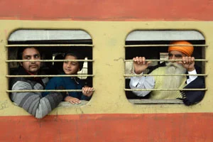 Passengers travel on a local train at the railway station in Amritsar on Tuesday