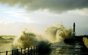 Strong winds whipped up huge waves for the most of October at the Seaburn Coast near Sunderland; (inset) a car is crushed under a fallen tree following the storm in London