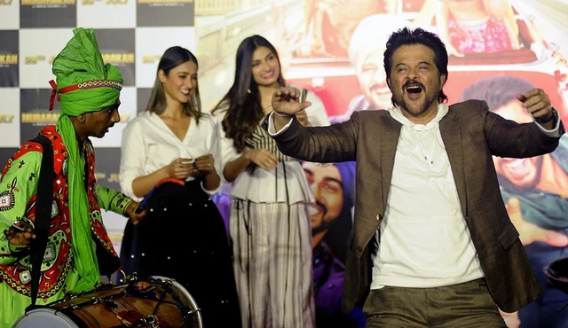 Indian Bollywood actor Anil Kapoor dances onstage during a promotional event for the forthcoming Hindi film ‘Mubarakan’ directed by Anees Bazmee in Mumbai on June 20, 2017. / AFP PHOTO / STR
