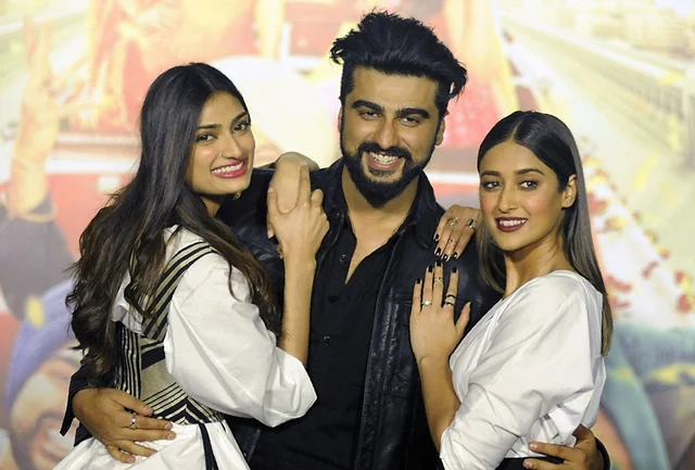 Indian Bollywood actors Athiya Shetty (L), Arjun Kapoor (C) and Ileana DCruz pose for a photograph during a promotional event for the forthcoming Hindi film ‘Mubarakan’ directed by Anees Bazmee in Mumbai on June 20, 2017. / AFP PHOTO / STR