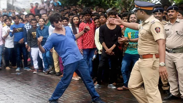 Mumbai: A fan strike a signature pose of actor Shahrukh Khan outside the actor’s residence in Mumbaiy. The actor came out to greet his fans on the occasion of Eid. PTI Photo by Mitesh Bhuvad
