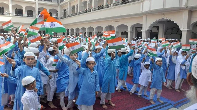 Moradabad: Muslim children hold the tricolour flag during the 71st Independence Day celebrations at a madrasa in Moradabad on Tuesday. PTI Photo<br />(PTI8_15_2017_000134B)