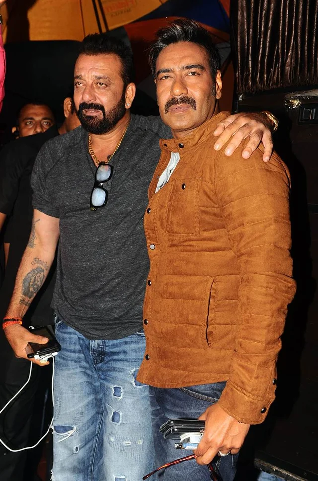 Indian Bollywood actors Sanjay Dutt (L) and Ajay Devgn pose for a photograph during a promotional event for the ‘Khatron Ke Khiladi’ reality show, based on the US format ‘Fear Factor’ in Mumbai on late September 19, 2017. / AFP PHOTO / STR