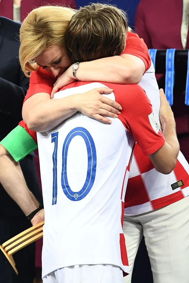 Croatian President Kolinda Grabar-Kitarovic (L) greets Croatia’s midfielder Luka Modric during the trophy ceremony at the end of the Russia 2018 World Cup final football match between France and Croatia at the Luzhniki Stadium in Moscow on July 15, 2018.
