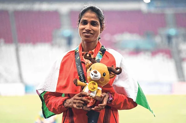 India’s Sudha Singh poses after winning silver medal in the women’s 3000m steeplechase event in Jakarta on Monday.