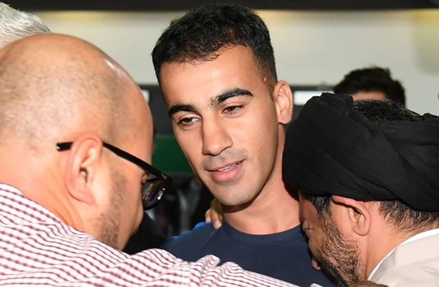 Supporters receive footballer Hakeem al-Araibi (C) upon his arrival at the airport in Melbourne on February 12, 2019. Photo by WILLIAM WEST / AFP