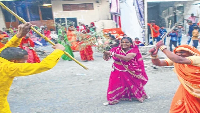 Women along with their husbands playing traditional Chhdimaar Holi