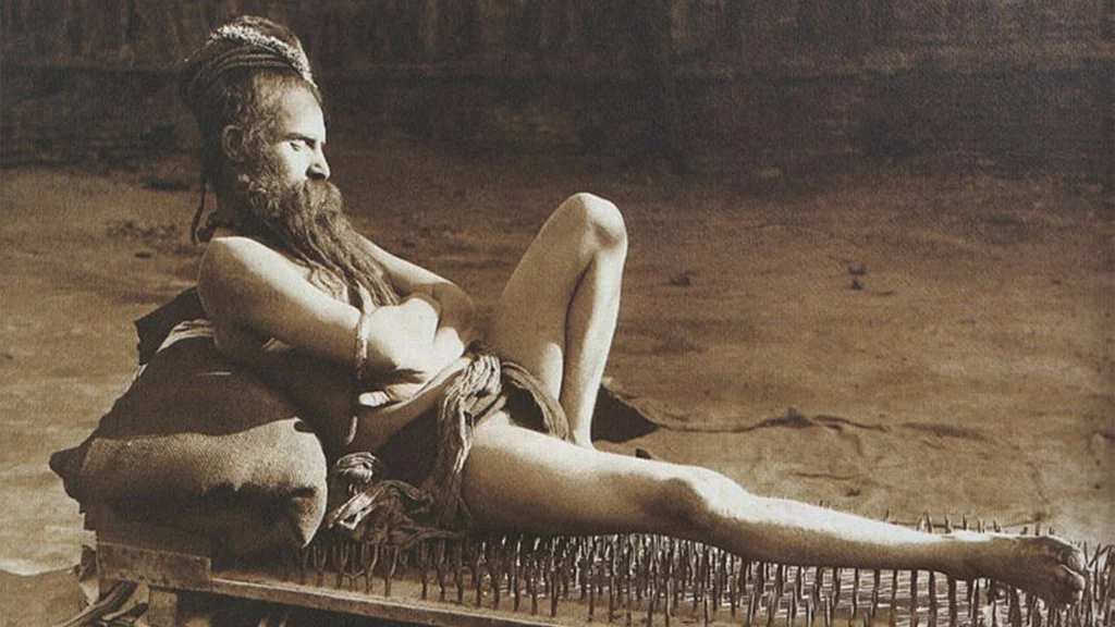 A <i>Naga Sanyasi</i> resting on a bed of nails