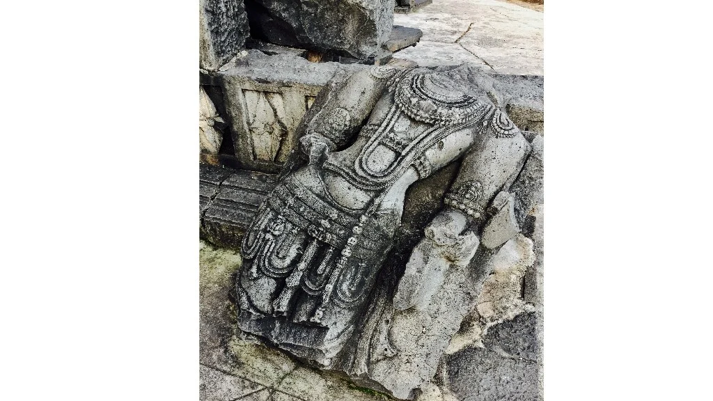 A defaced statuette at the entrance