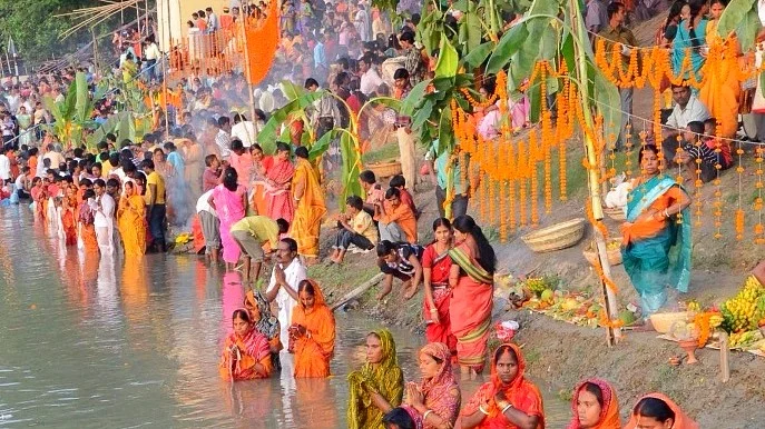 Ritual of taking a dip in the water of Chhath Puja 
