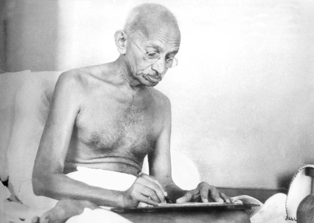 Gandhi writing a document